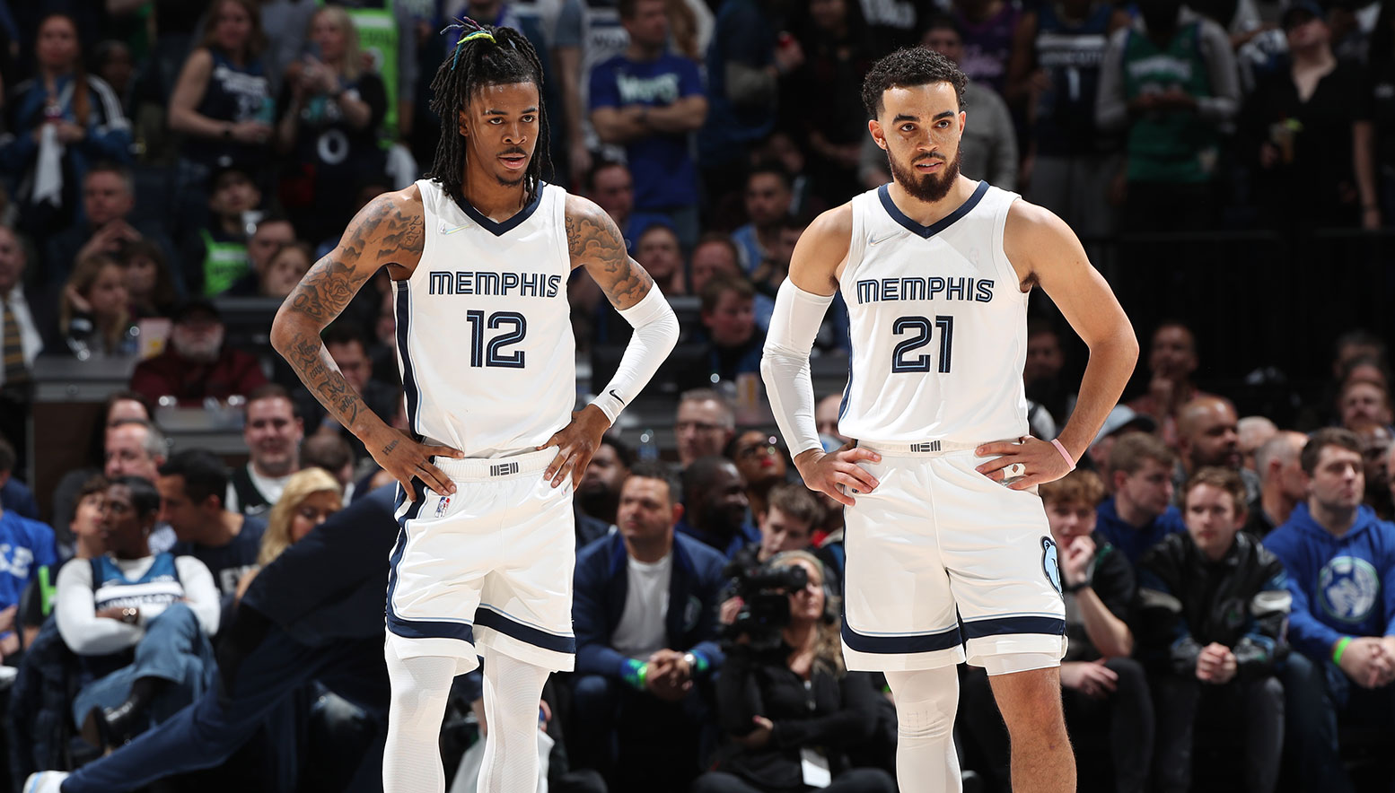 MINNEAPOLIS, MN - APRIL 21: Ja Morant #12 of the Memphis Grizzlies and Tyus Jones #21 of the Memphis Grizzlies look on during Round 1 Game 3 of the 2022 NBA Playoffs on April 21, 2022 at Target Center in Minneapolis, Minnesota.