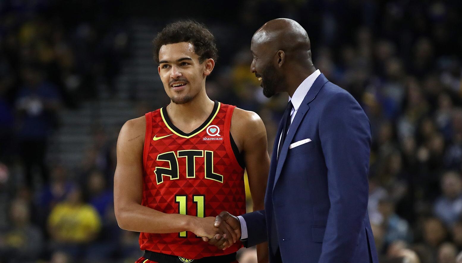 Trae Young shakes hands with Lloyd Pierce