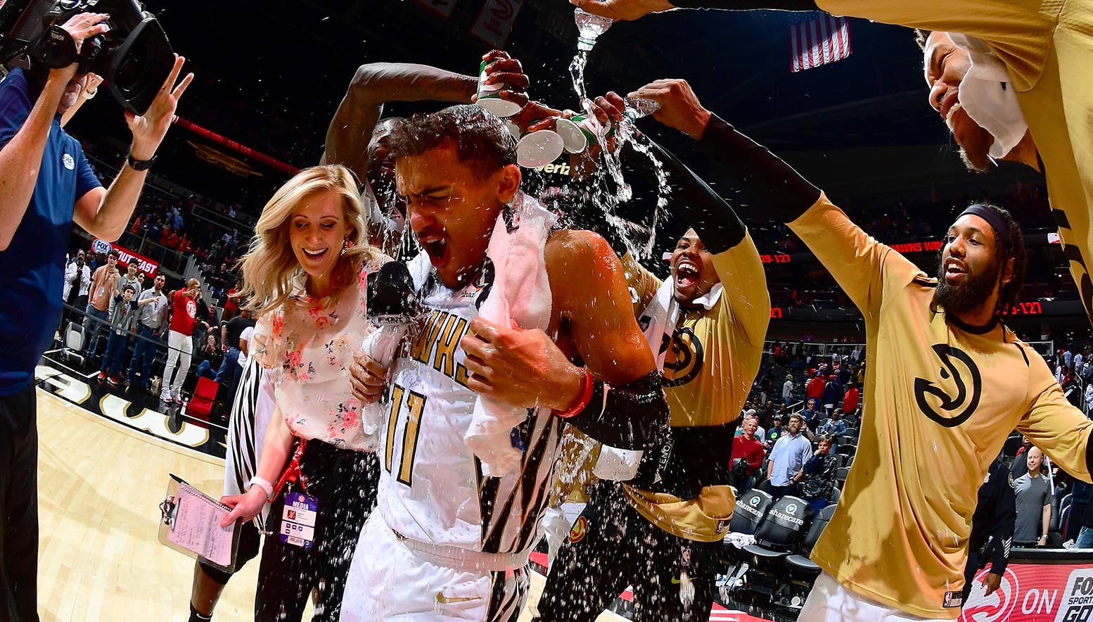 Trae Young is showered by teammates after victory