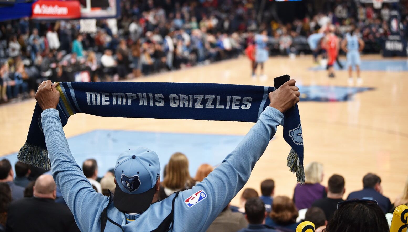 Grizzlies fan holding up a scarf