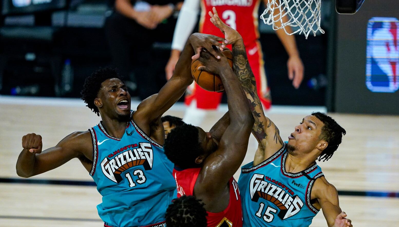 Jaren Jackson Jr. and Brandon Clarke blocking Zion Williamson