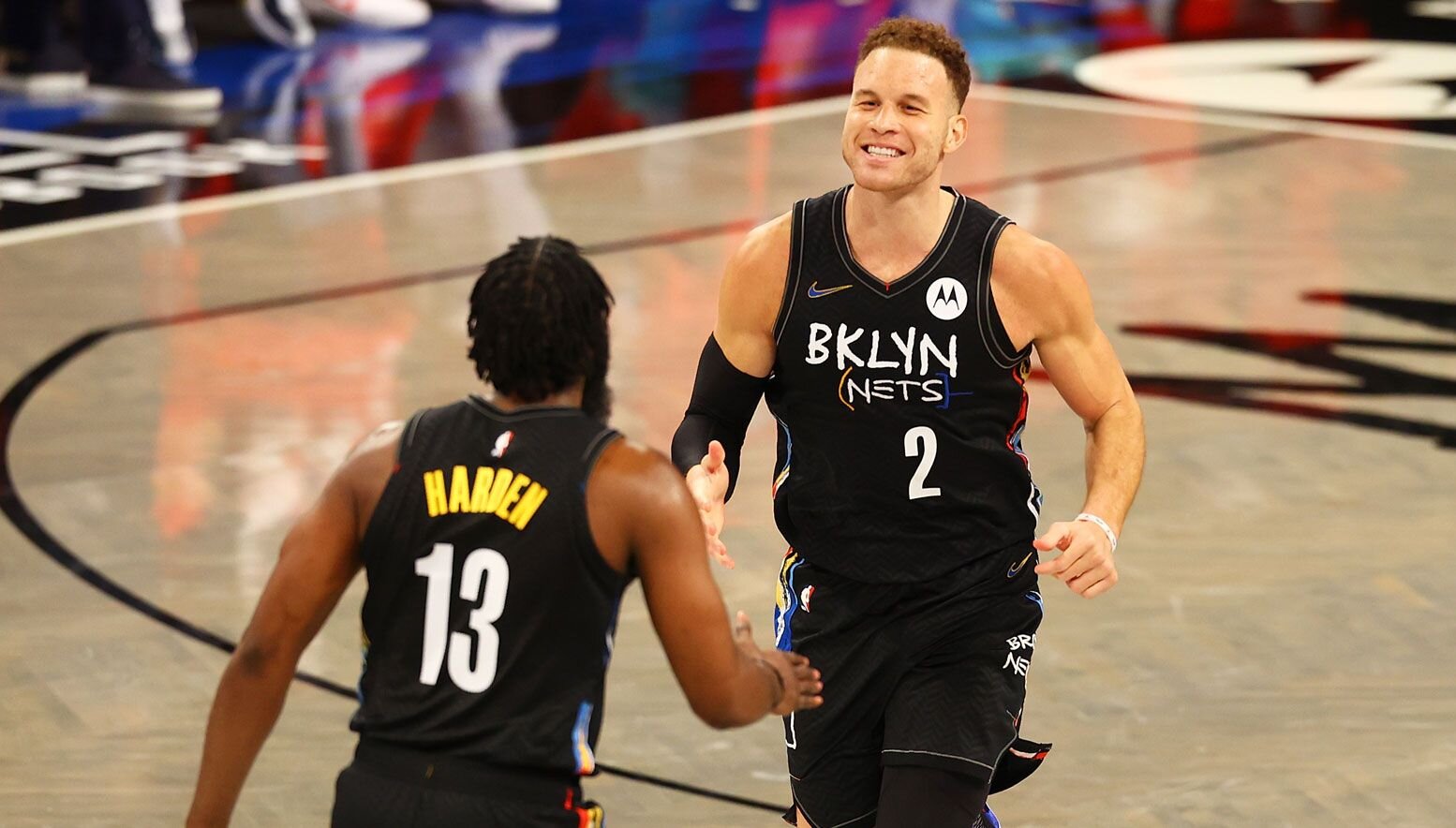 Blake Griffin smiling with James Harden