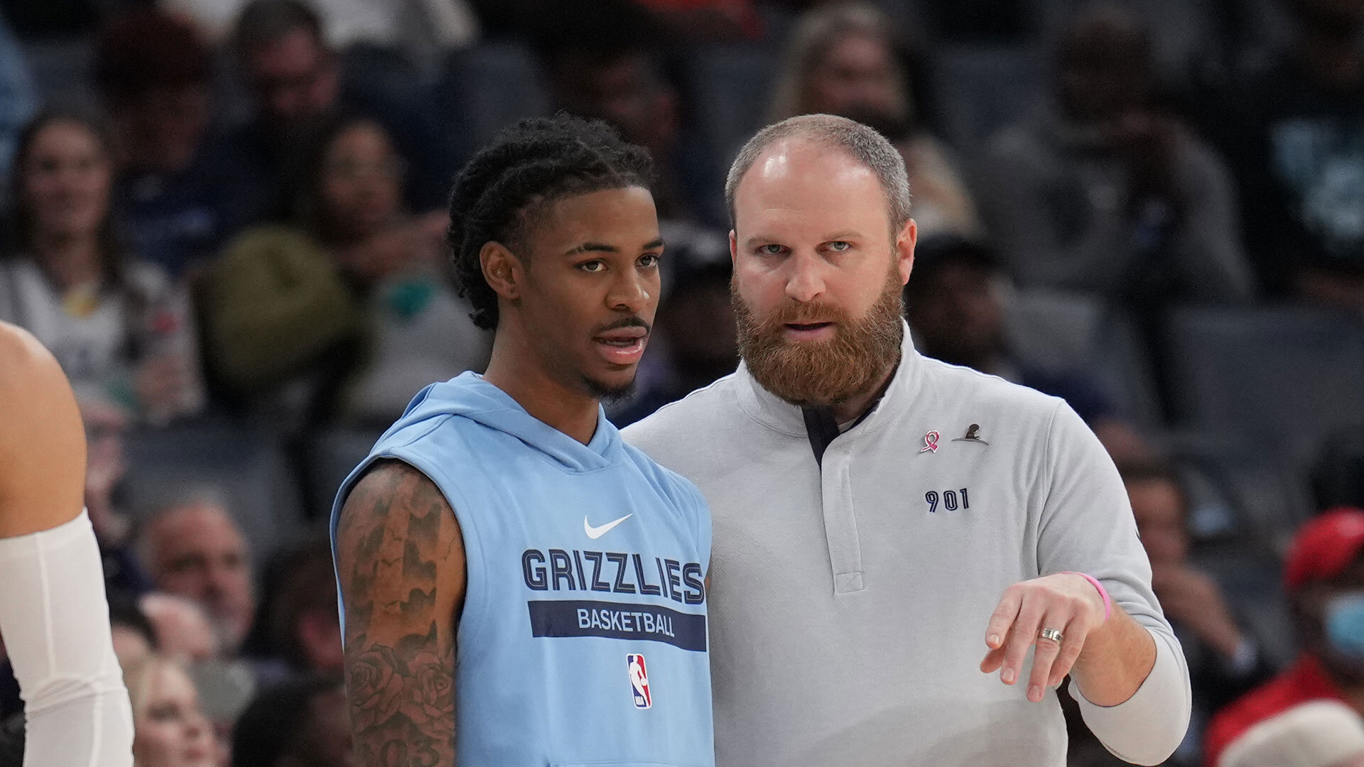 MEMPHIS, TN - OCTOBER 7: Ja Morant #12 of the Memphis Grizzlies talks with Head Coach Taylor Jenkins of the Memphis Grizzlies during a preseason game on October 7, 2022 at FedExForum in Memphis, Tennessee. Photo by Jesse D. Garrabrant/NBAE via Getty Images