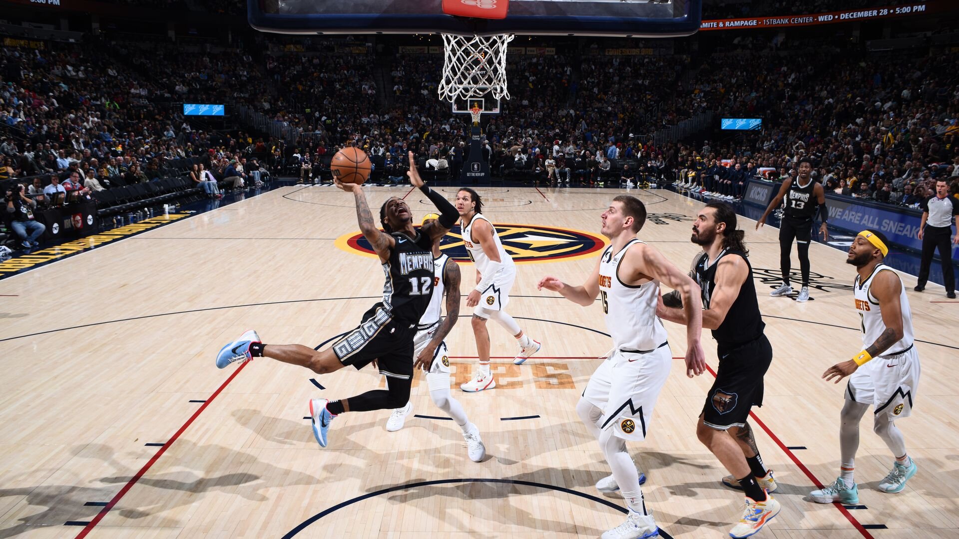 DENVER, CO - DECEMBER 20: Ja Morant #12 of the Memphis Grizzlies drives to the basket during the game on December 20, 2022 at the Ball Arena in Denver, Colorado.