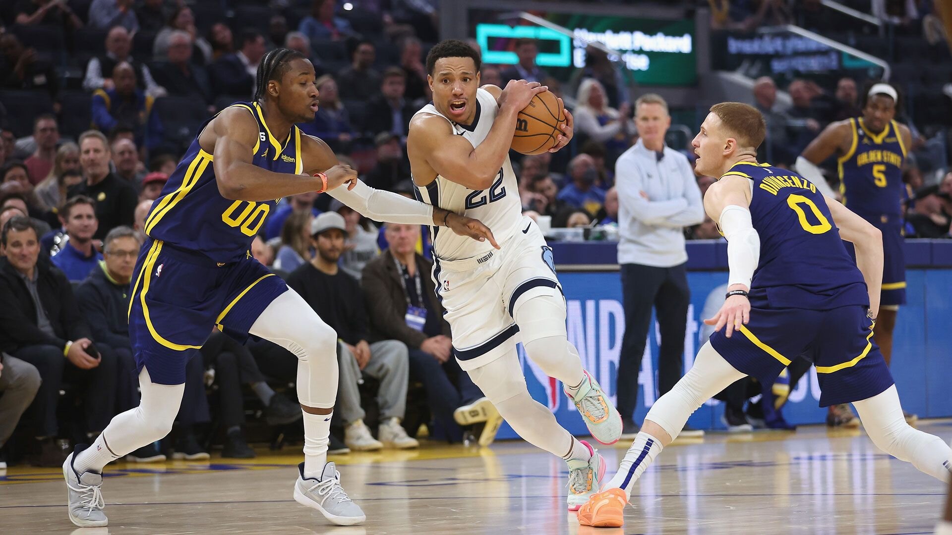 SAN FRANCISCO, CALIFORNIA - JANUARY 25: Desmond Bane #22 of the Memphis Grizzlies drives to the basket against Jonathan Kuminga #00 and Donte DiVincenzo #0 of the Golden State Warriors in the second quarter at Chase Center on January 25, 2023 in San Francisco, California.