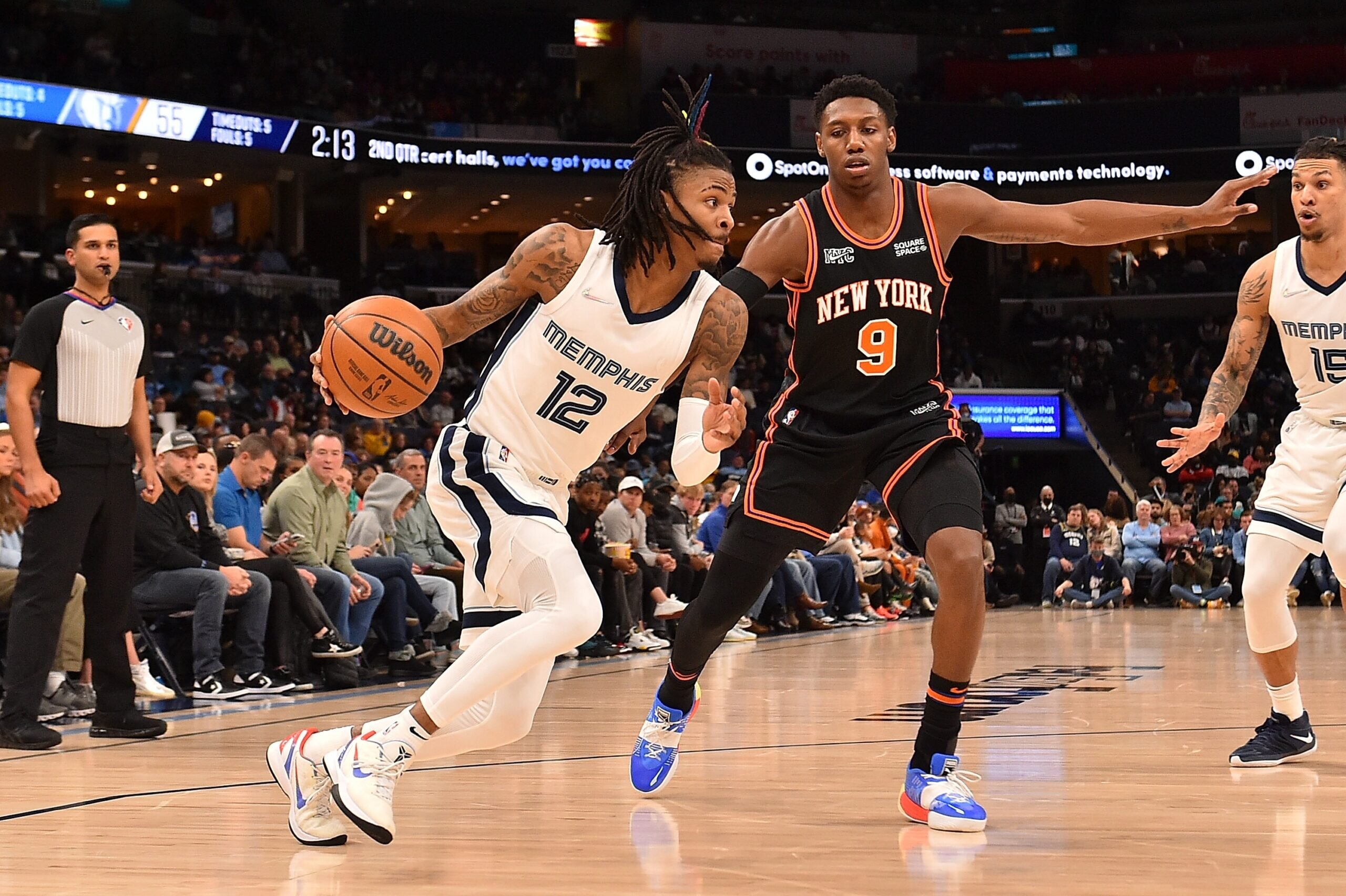 MEMPHIS, TENNESSEE - MARCH 11: Ja Morant #12 of the Memphis Grizzlies handles the ball against RJ Barrett #9 of the New York Knicks during the first half at FedExForum on March 11, 2022 in Memphis, Tennessee.