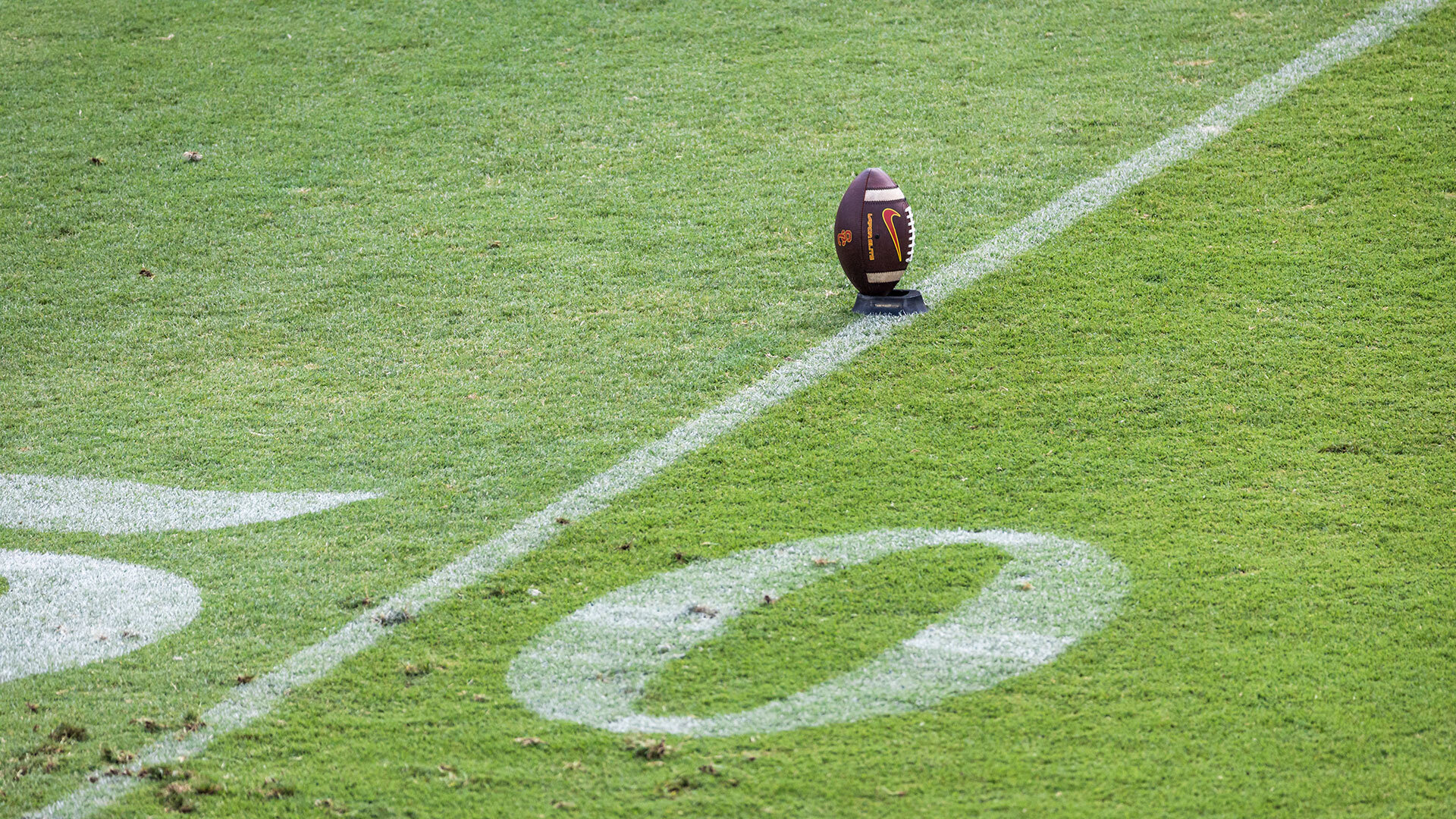 A football sits on a kicking tee