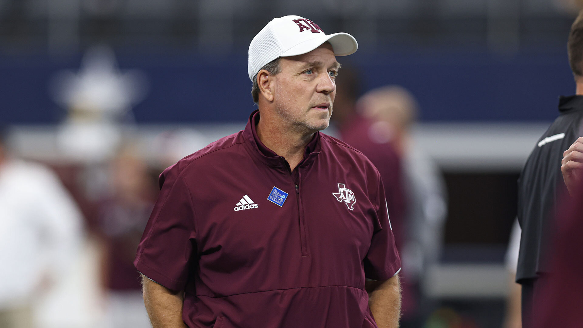 Texas A&M coach Jimbo Fisher watches his team warm up before the Southwest Classic between the Arkansas Razorbacks and the Texas A&M Aggies