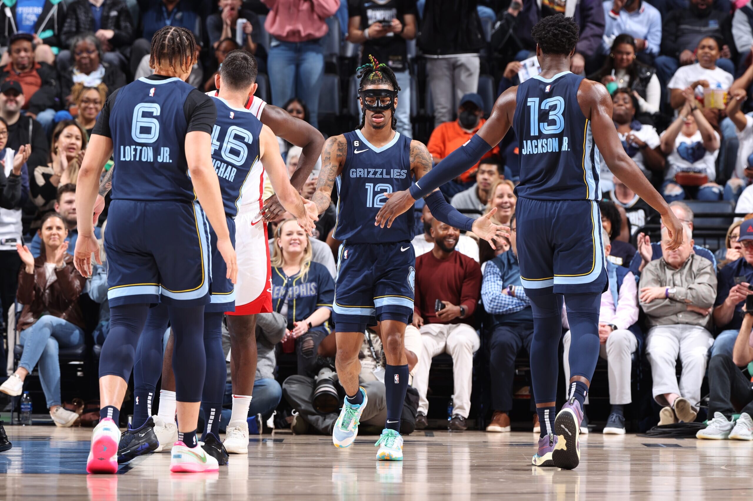 MEMPHIS, TN - MARCH 22: Ja Morant #12 of the Memphis Grizzlies high fives teammates during the game against the Houston Rockets on March 22, 2023 at FedExForum in Memphis, Tennessee. NOTE TO USER: User expressly acknowledges and agrees that, by downloading and or using this photograph, User is consenting to the terms and conditions of the Getty Images License Agreement. Mandatory Copyright Notice: Copyright 2023 NBAE (Photo by Joe Murphy/NBAE via Getty Images)