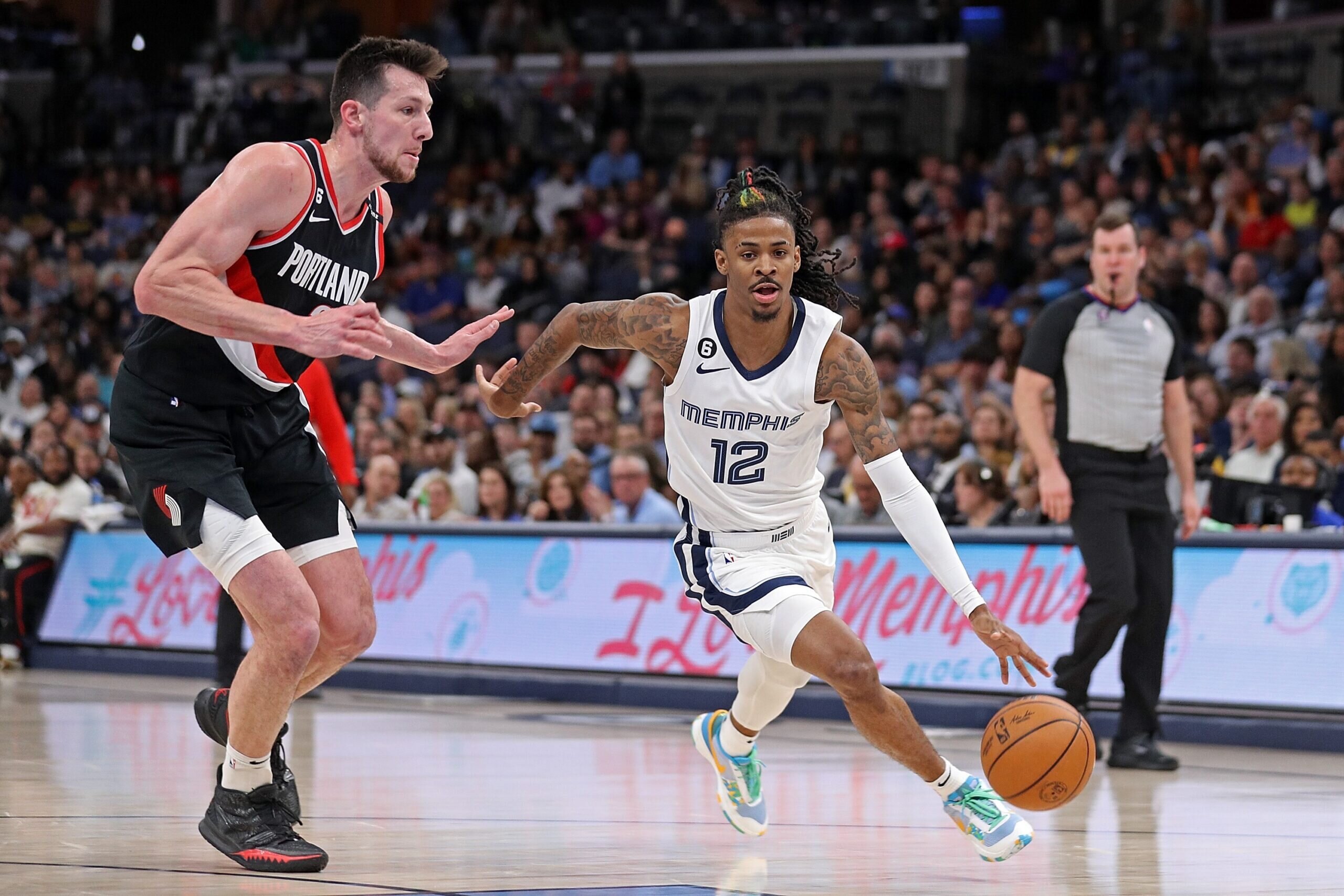 MEMPHIS, TENNESSEE - APRIL 04: Ja Morant #12 of the Memphis Grizzlies handles the ball against Drew Eubanks #24 of the Portland Trail Blazers during the first half at FedExForum on April 04, 2023 in Memphis, Tennessee.