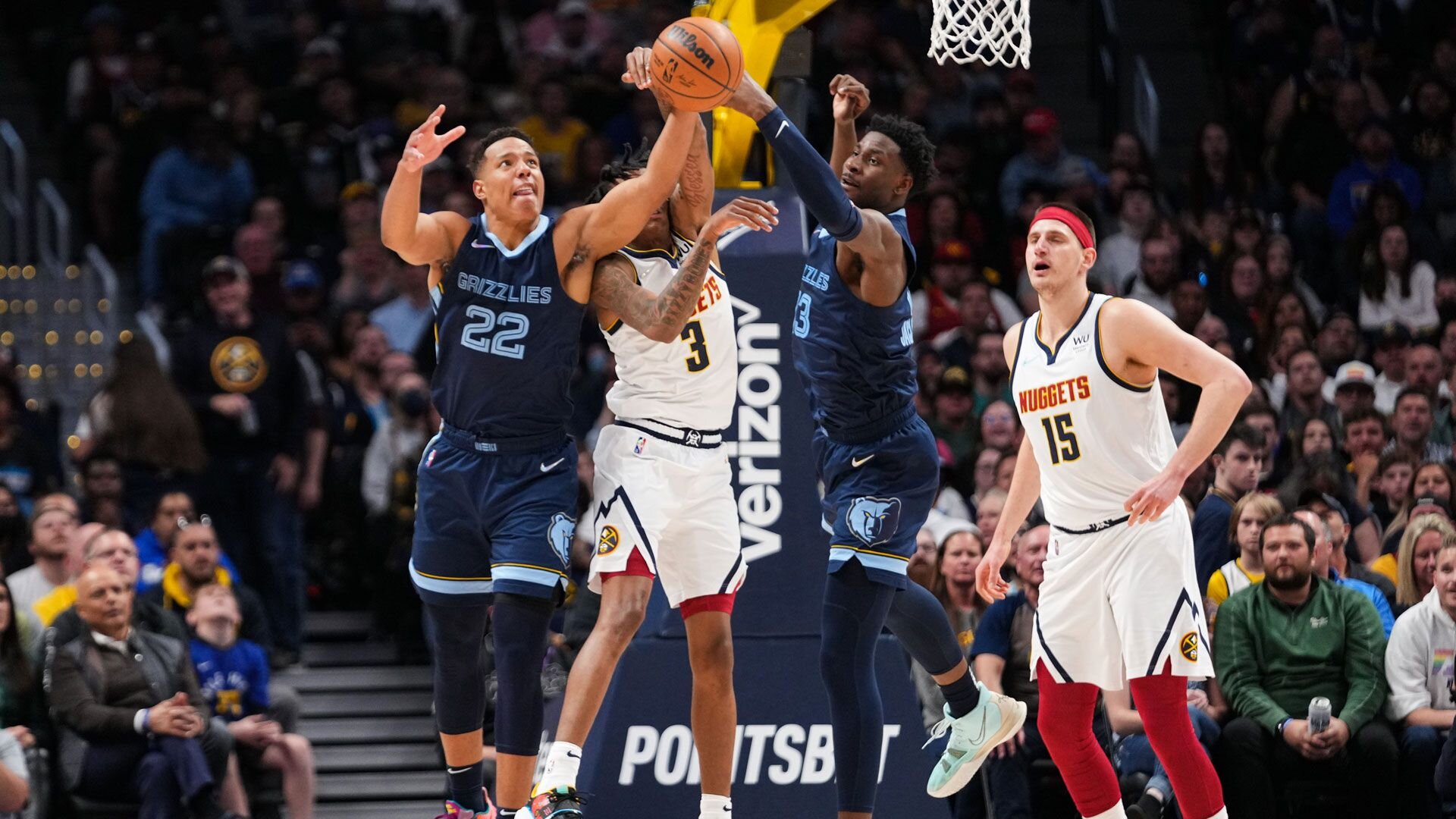 DENVER, CO - APRIL 07: Desmond Bane #22 and Jaren Jackson Jr. #13 of the Memphis Grizzlies jump for a rebound against Bones Hyland #3 of the Denver Nuggets at Ball Arena on April 7, 2022 in Denver, Colorado.