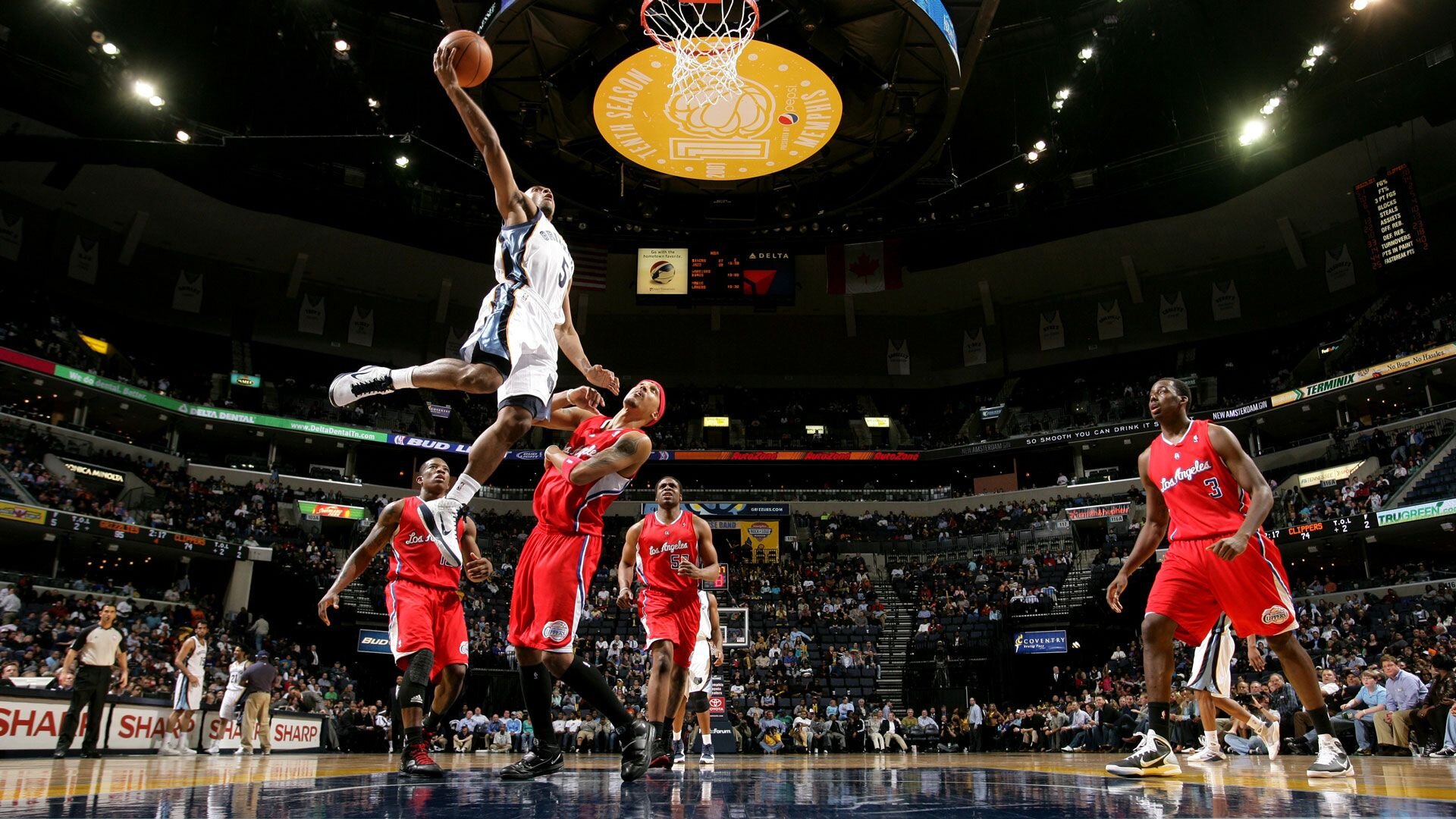 MEMPHIS, TN - MARCH 14: Ish Smith #5 of the Memphis Grizzlies shoots a layup over Jamario Moon #8 of the Los Angeles Clippers on March 14, 2011 at FedExForum in Memphis, Tennessee.