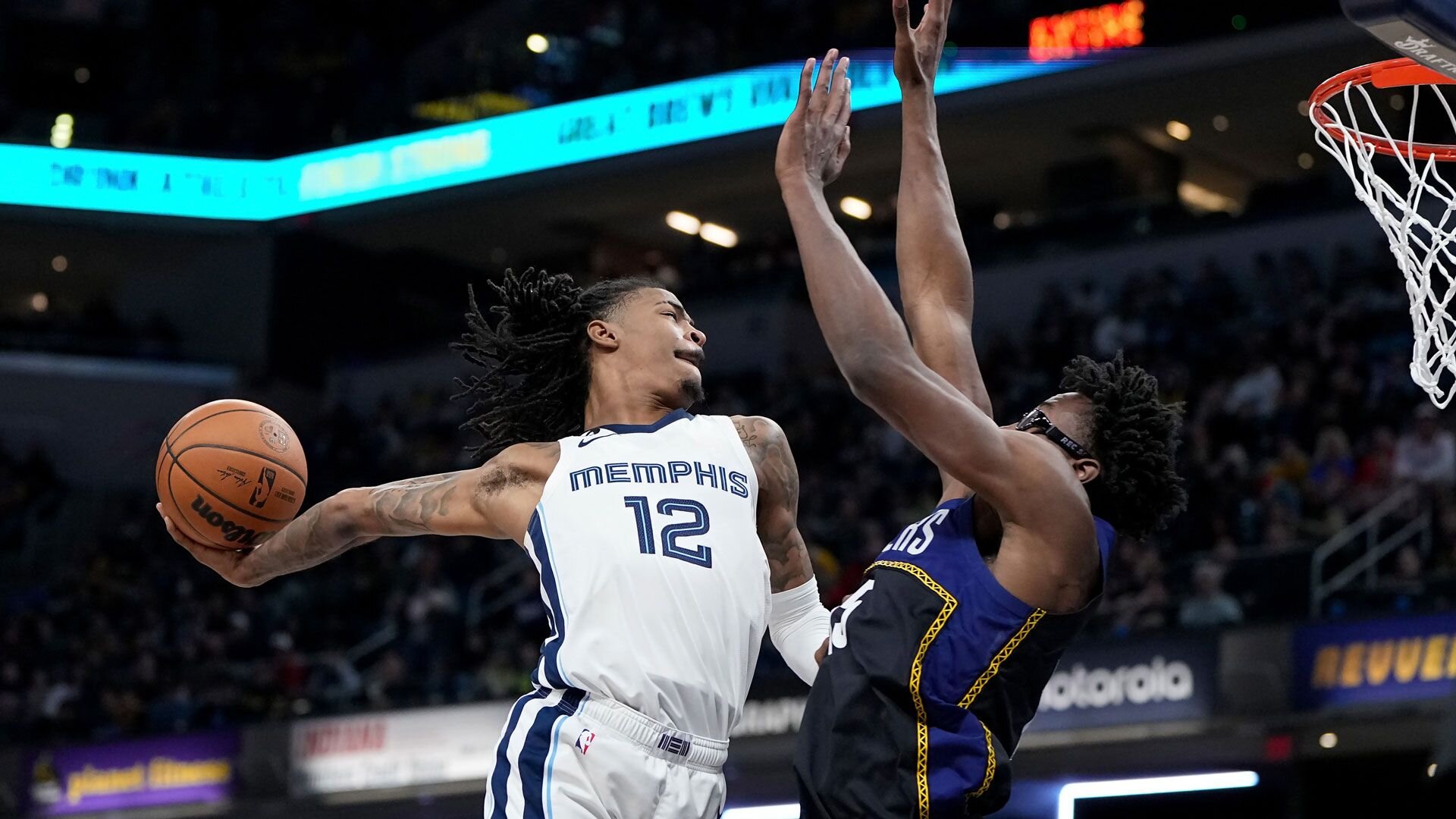 INDIANAPOLIS, INDIANA - JANUARY 14: Ja Morant #12 of the Memphis Grizzlies dunks the ball over Jalen Smith #25 of the Indiana Pacers in the third quarter at Gainbridge Fieldhouse on January 14, 2023 in Indianapolis, Indiana.