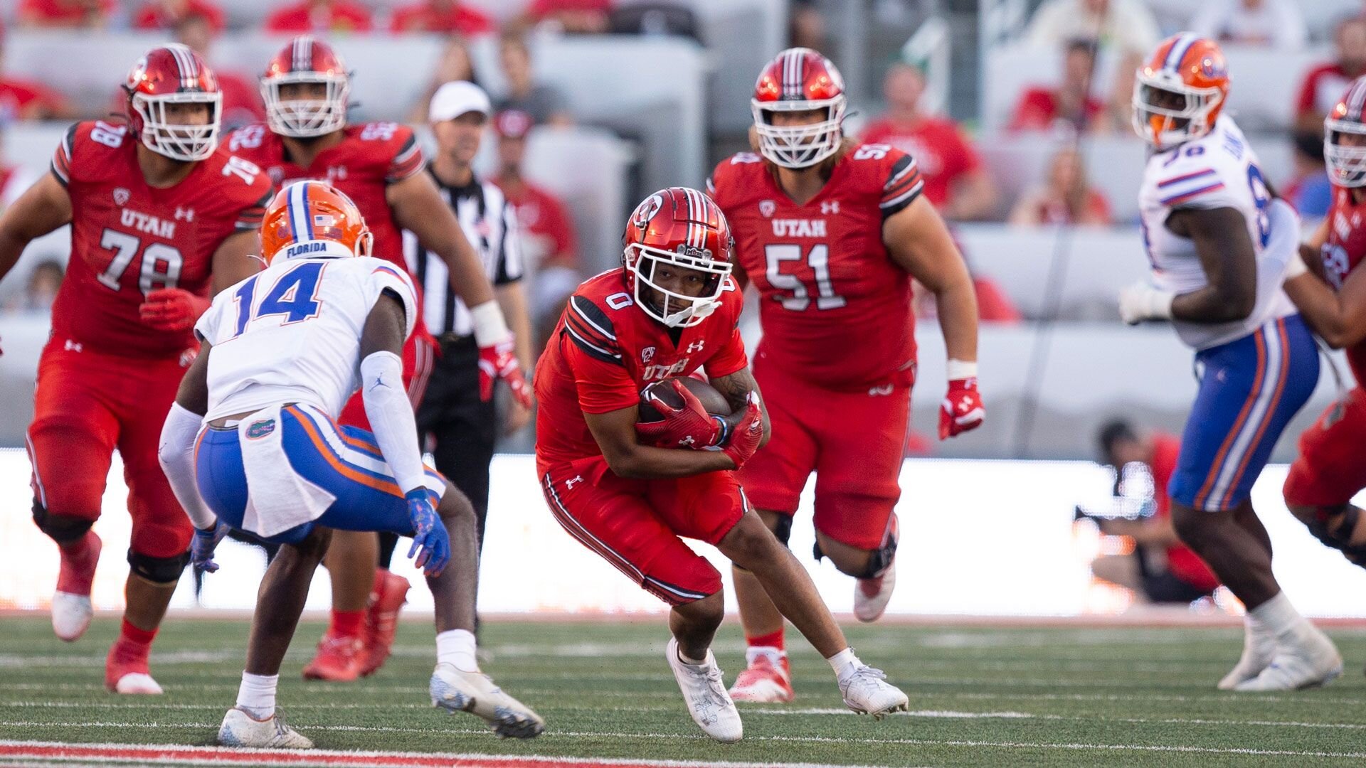 SALT LAKE CITY, UT - AUGUST 31: Mikey Matthews #0 of the Utah Utes runs the ball agaisnt Jordan Castell #14 of the Florida Gators during the fist half of their game at Rice Eccles Stadium August 31, 2023 in Salt Lake City, Utah. (Photo by Chris Gardner/Getty Images)