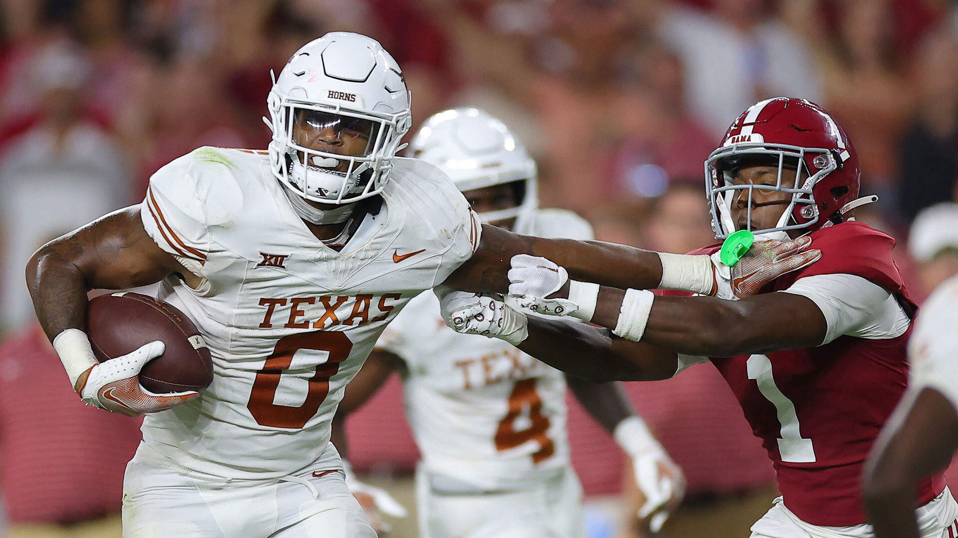 TUSCALOOSA, ALABAMA - SEPTEMBER 09: Anthony Hill Jr. #0 of the Texas Longhorns avoids a tackle by Kool-Aid McKinstry #1 of the Alabama Crimson Tide during the fourth quarter at Bryant-Denny Stadium on September 09, 2023 in Tuscaloosa, Alabama. (Photo by Kevin C. Cox/Getty Images)