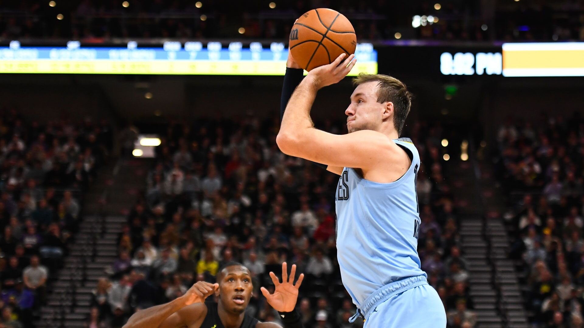 SALT LAKE CITY, UTAH - NOVEMBER 01: Luke Kennard #10 of the Memphis Grizzlies shoots over Kris Dunn #11 of the Utah Jazz during the first half of a game at Delta Center on November 01, 2023 in Salt Lake City, Utah.