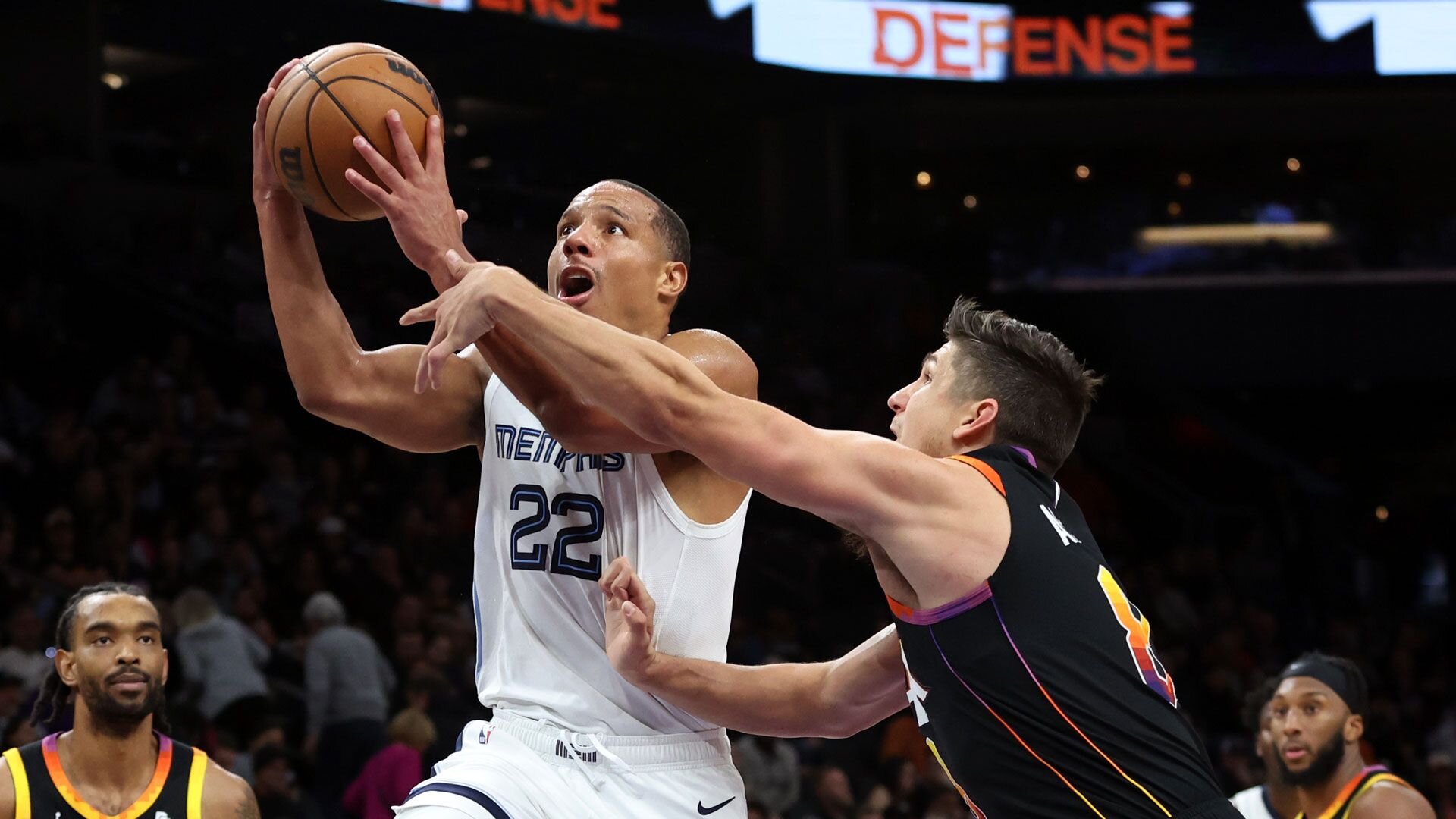 PHOENIX, ARIZONA - DECEMBER 02: Desmond Bane #22 of the Memphis Grizzlies shoots a basket against Grayson Allen #8 of the Phoenix Suns during the fourth quarter at Footprint Center on December 02, 2023 in Phoenix, Arizona.