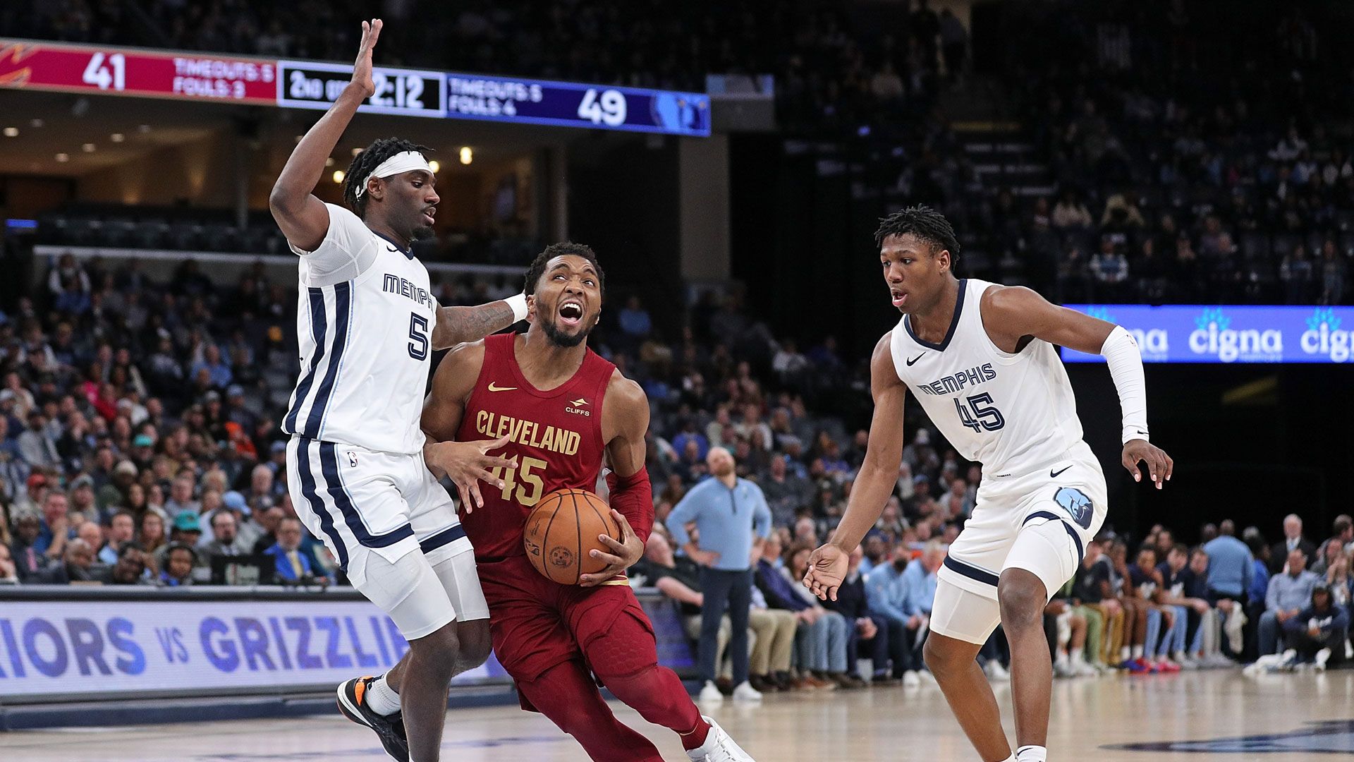 MEMPHIS, TENNESSEE - FEBRUARY 01: Donovan Mitchell #45 of the Cleveland Cavaliers handles the ball between Vince Williams Jr. #5 of the Memphis Grizzlies and GG Jackson #45 of the Memphis Grizzlies during the game at FedExForum on February 01, 2024 in Memphis, Tennessee.