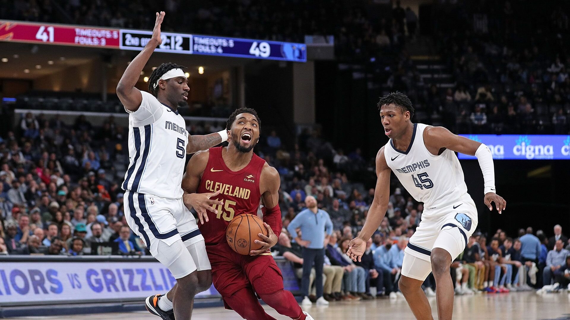 MEMPHIS, TENNESSEE - FEBRUARY 01: Donovan Mitchell #45 of the Cleveland Cavaliers handles the ball between Vince Williams Jr. #5 of the Memphis Grizzlies and GG Jackson #45 of the Memphis Grizzlies during the game at FedExForum on February 01, 2024 in Memphis, Tennessee.