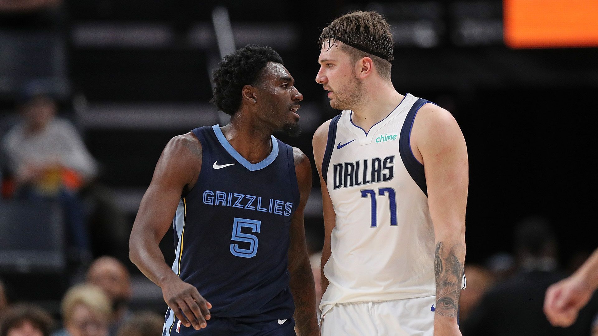 MEMPHIS, TENNESSEE - DECEMBER 11: Vince Williams Jr. #5 of the Memphis Grizzlies and Luka Doncic #77 of the Dallas Mavericks interact during the second half at FedExForum on December 11, 2023 in Memphis, Tennessee.