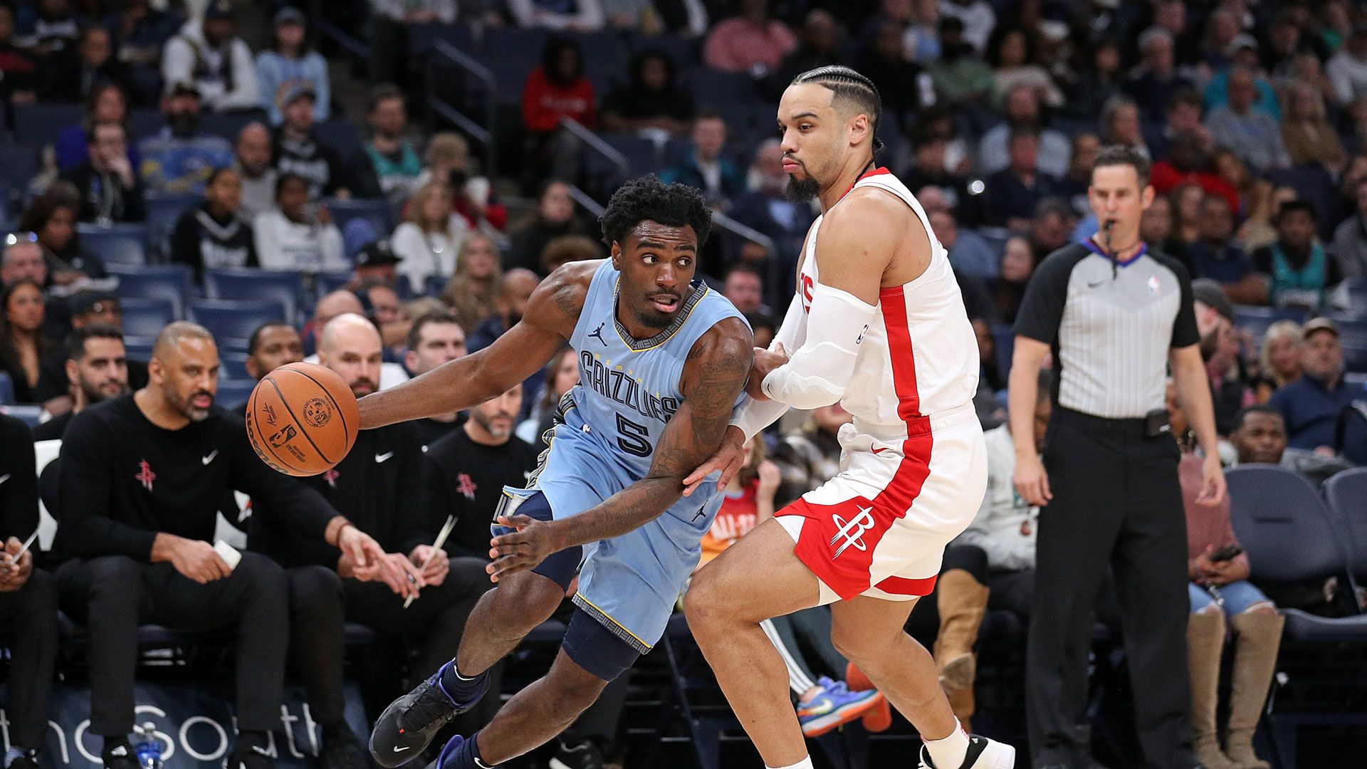 MEMPHIS, TENNESSEE - DECEMBER 15: Vince Williams Jr. #5 of the Memphis Grizzlies handles the ball against Dillon Brooks #9 of the Houston Rockets during the game at FedExForum on December 15, 2023 in Memphis, Tennessee.