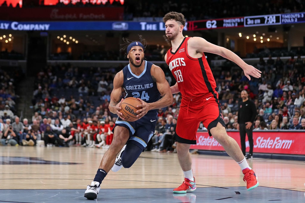 MEMPHIS, TENNESSEE - FEBRUARY 14: Lamar Stevens #24 of the Memphis Grizzlies drives to the basket against Alperen Sengun #28 of the Houston Rockets during the second half at FedExForum on February 14, 2024 in Memphis, Tennessee.