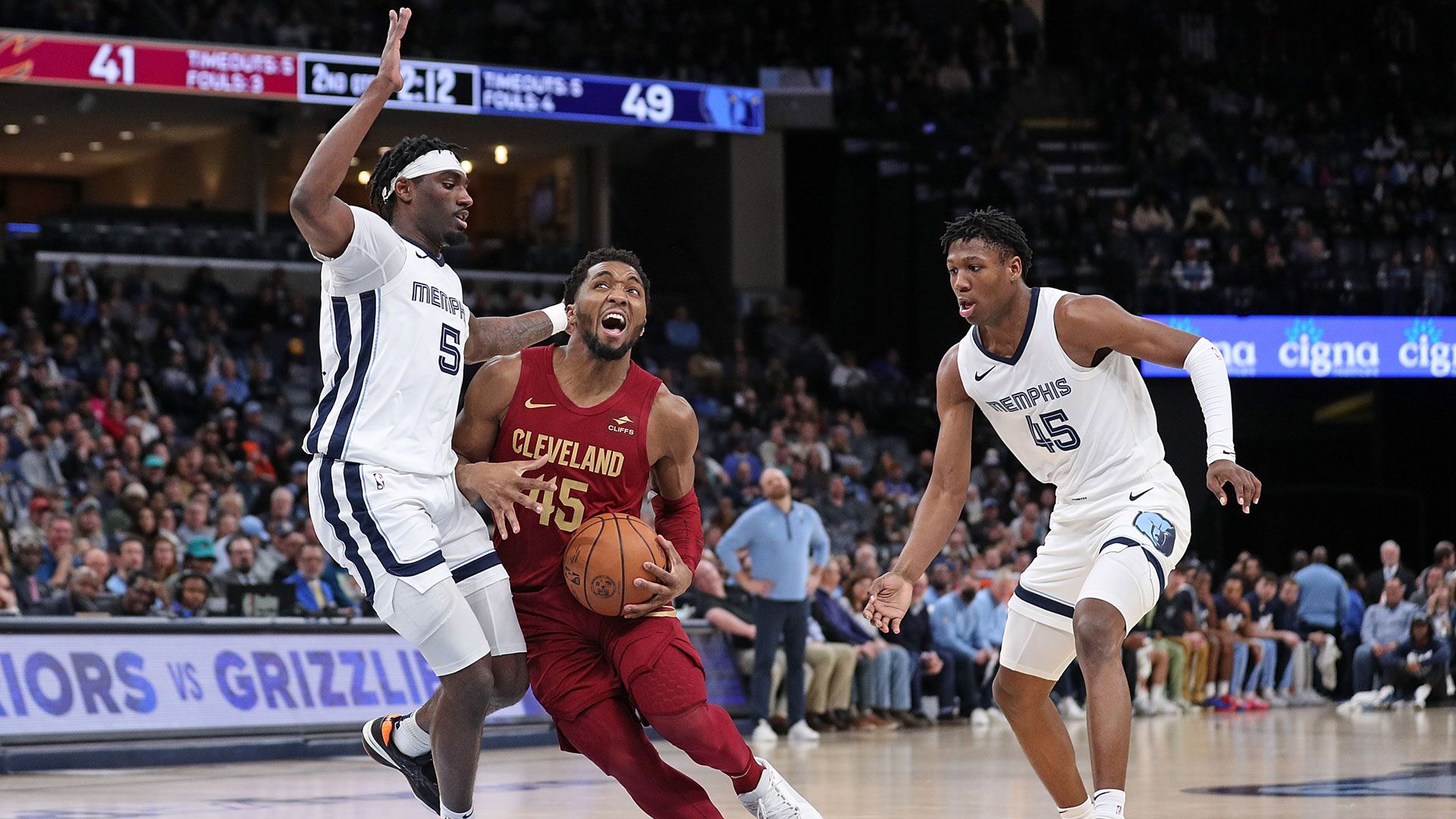 MEMPHIS, TENNESSEE - FEBRUARY 01: Vince Williams Jr. #5 of the Memphis Grizzlies and GG Jackson #45 of the Memphis Grizzlies defend against Donovan Mitchell #45 of the Cleveland Cavaliers  during the game at FedExForum on February 01, 2024 in Memphis, Tennessee.