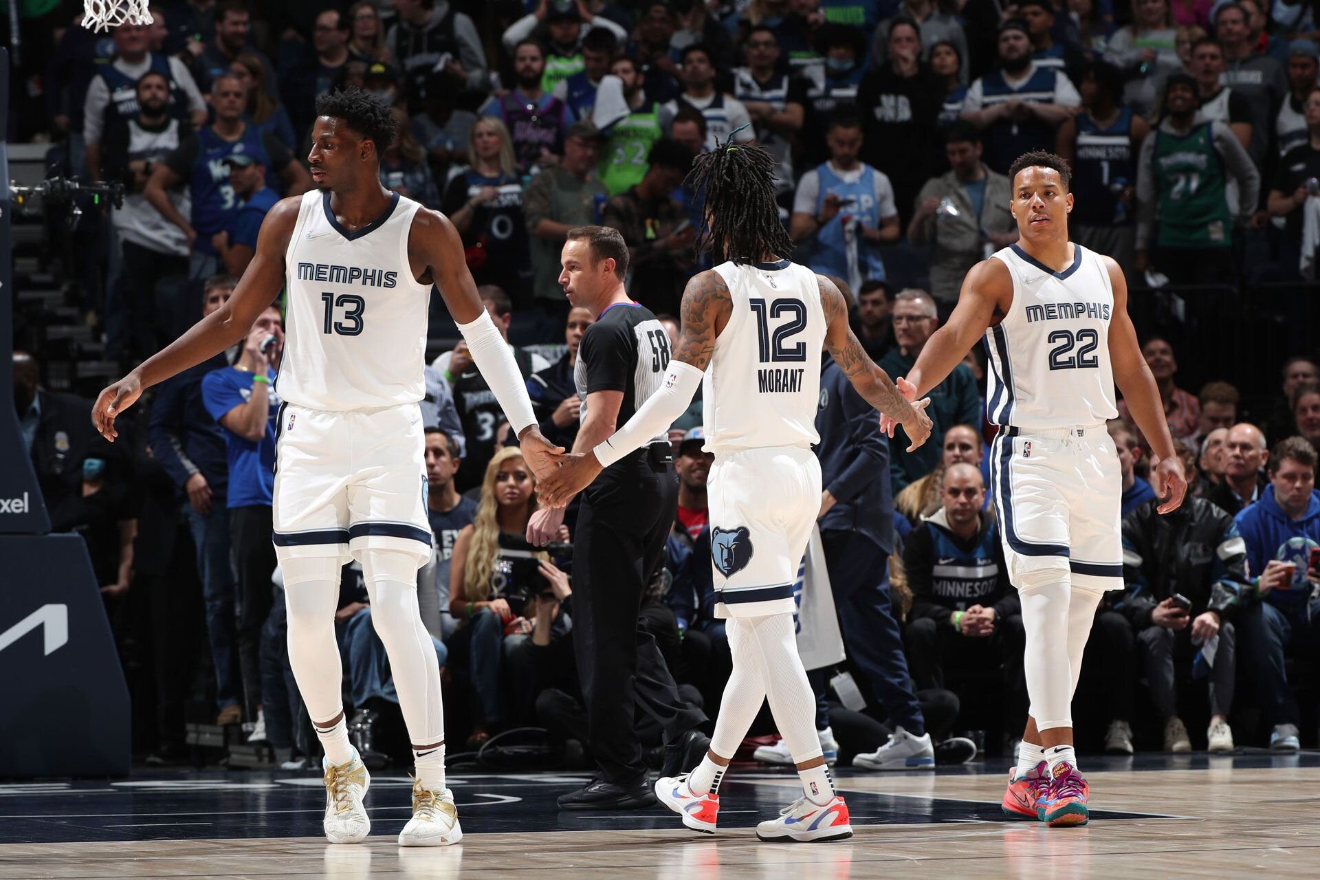MINNEAPOLIS, MN -  APRIL 21: Jaren Jackson Jr. #13 and Desmond Bane #22 high five Ja Morant #12 of the Memphis Grizzlies during Round 1 Game 3 of the 2022 NBA Playoffs on April 21, 2022 at Target Center in Minneapolis, Minnesota.