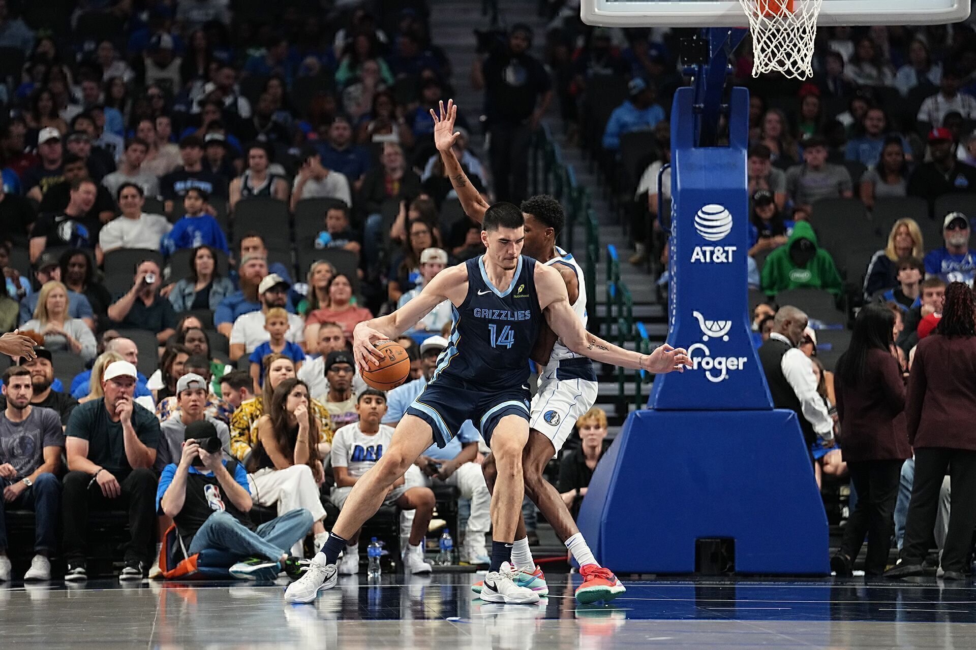 DALLAS, TX - OCTOBER 7: Zach Edey #14 of the Memphis Grizzlies handles the ball during the game against the Dallas Mavericks during the 2024 NBA Preseason on October 7, 2024 at American Airlines Center in Dallas, Texas.