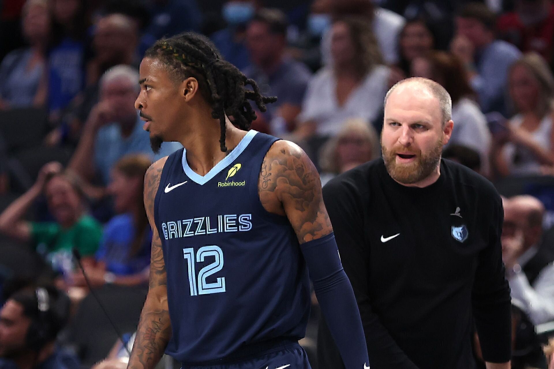 DALLAS, TX - OCTOBER 7: Ja Morant #12 of the Memphis Grizzlies walks past head coach Taylor Jenkins in the first half of a preseason game against the Dallas Mavericks at American Airlines Center on October 7, 2024 in Dallas, Texas.