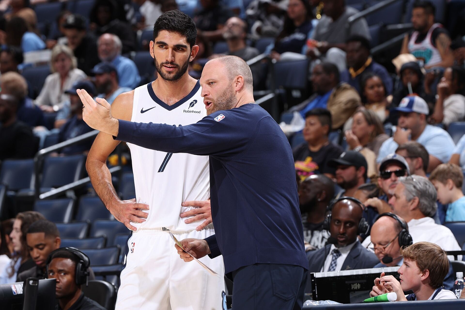 MEMPHIS, TN - OCTOBER 10: Santi Aldama #7 and Head Coach Taylor Jenkins of the Memphis Grizzlies speak to each other during the game against the Charlotte Hornets during a NBA Preseason game on October 10, 2024 at FedExForum in Memphis, Tennessee.