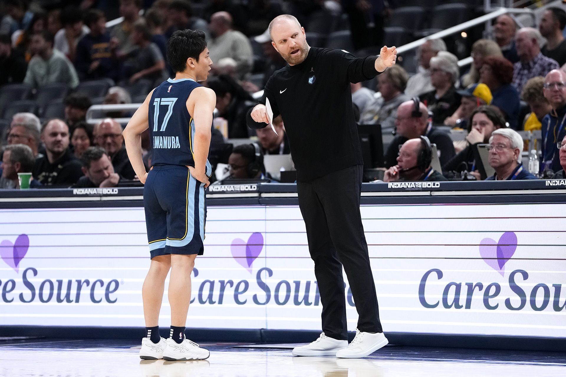 INDIANAPOLIS, INDIANA - OCTOBER 14: Head coach Taylor Jenkins of the Memphis Grizzlies meets with Yuki Kawamura #17 in the fourth quarter against the Indiana Pacers during a preseason game at Gainbridge Fieldhouse on October 14, 2024 in Indianapolis, Indiana.