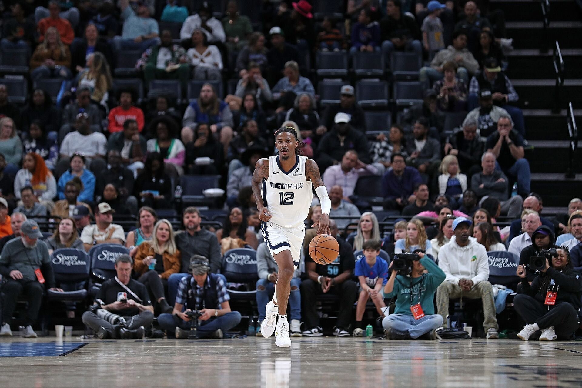 MEMPHIS, TENNESSEE - OCTOBER 18: Ja Morant #12 of the Memphis Grizzlies brings the ball up court during the game against the Miami Heat at FedExForum on October 18, 2024 in Memphis, Tennessee.