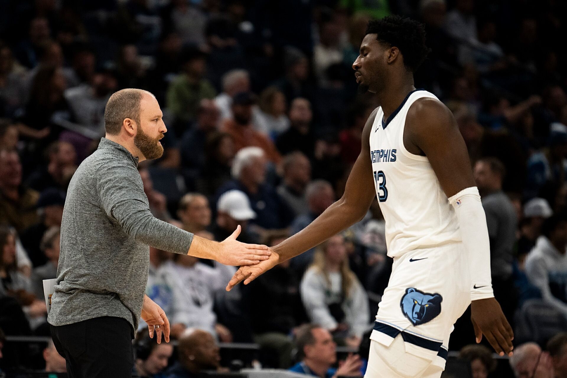 MINNEAPOLIS, MINNESOTA - FEBRUARY 28:  Head coach Taylor Jenkins of the Memphis Grizzlies slaps hands with Jaren Jackson Jr. #13 during a timeout in the fourth quarter  against the Minnesota Timberwolves at Target Center on February 28, 2024 in Minneapolis, Minnesota.