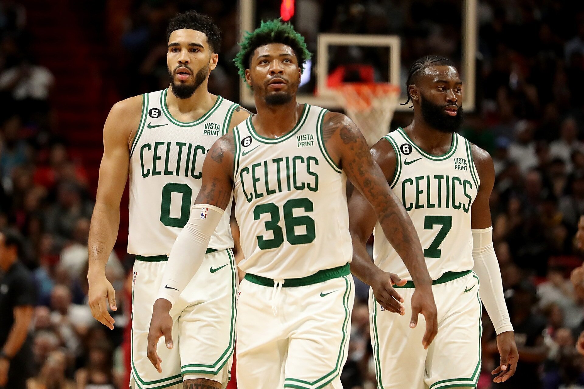 MIAMI, FLORIDA - OCTOBER 21: Jayson Tatum #0, Marcus Smart #36 of the Boston Celtics and Jaylen Brown #7 of the Boston Celtics look on against the Miami Heat during the third quarter at FTX Arena on October 21, 2022 in Miami, Florida.