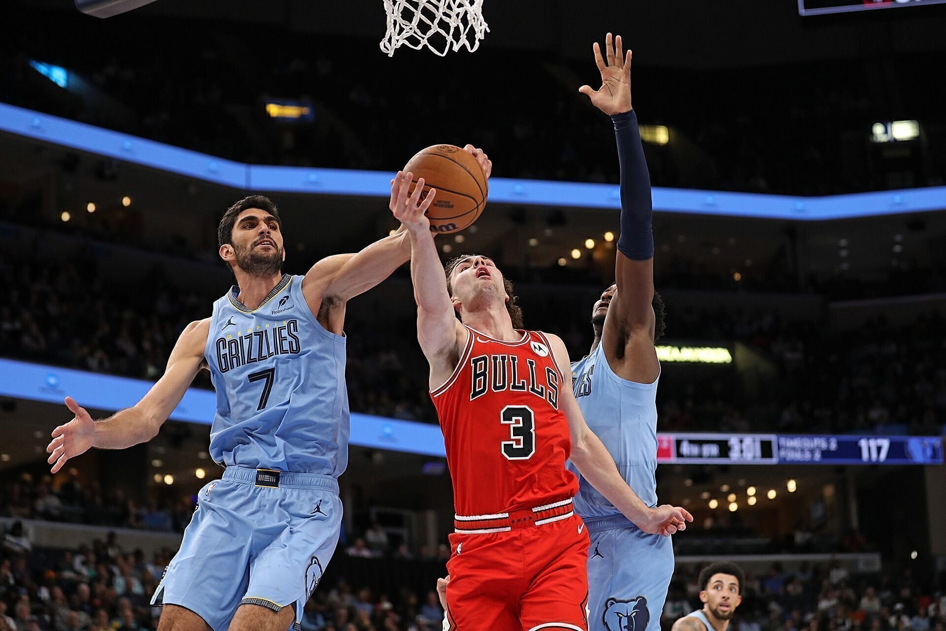 MEMPHIS, TENNESSEE - OCTOBER 28: Josh Giddey #3 of the Chicago Bulls goes to the basket and gets his shot blocked by Santi Aldama #7 of the Memphis Grizzlies during the second half at FedExForum on October 28, 2024 in Memphis, Tennessee.