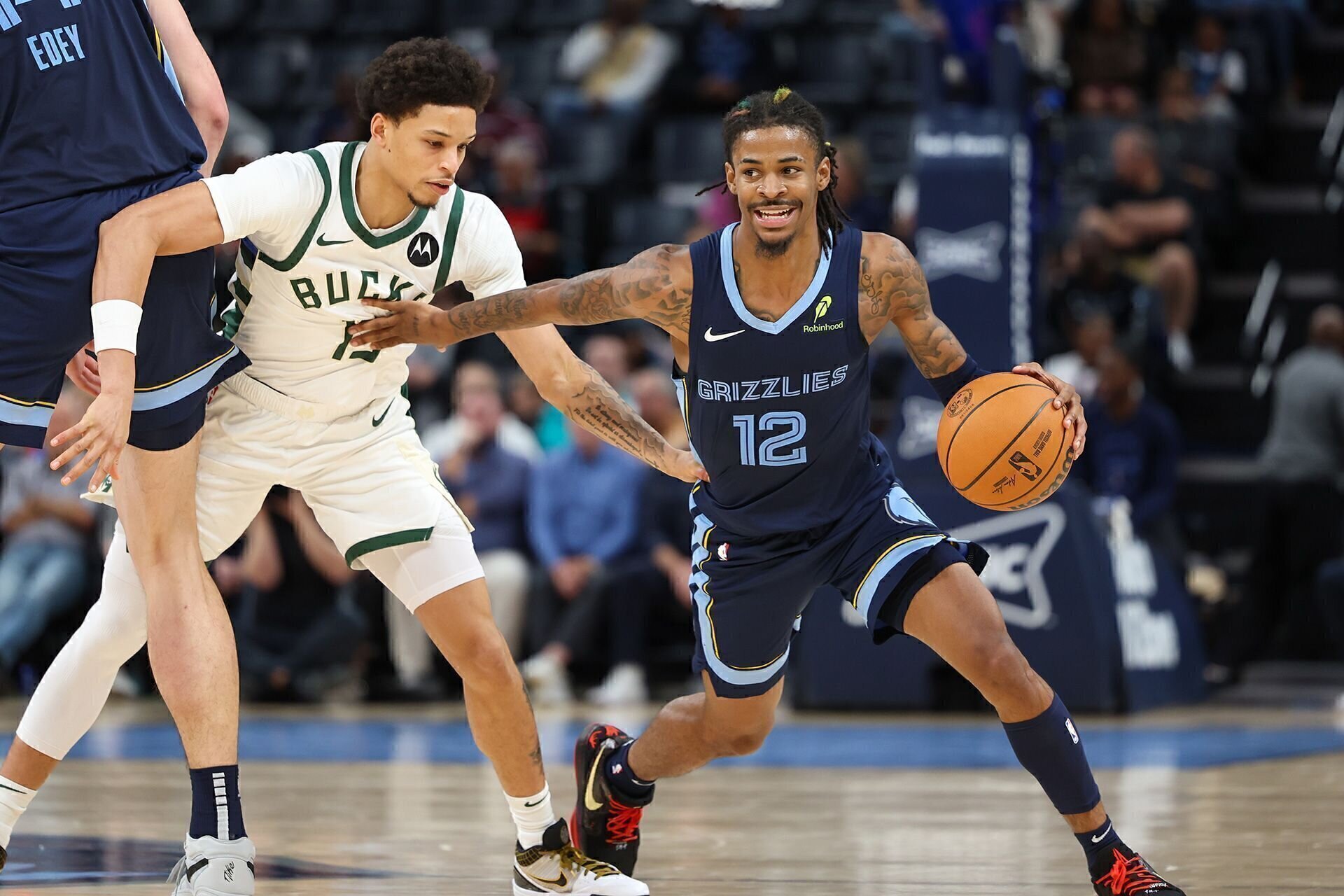 MEMPHIS, TENNESSEE - OCTOBER 31: Ja Morant #12 of the Memphis Grizzlies dribbles the ball against Ryan Rollins #13 of the Milwaukee Bucks during the fourth quarter at FedExForum on October 31, 2024 in Memphis, Tennessee.