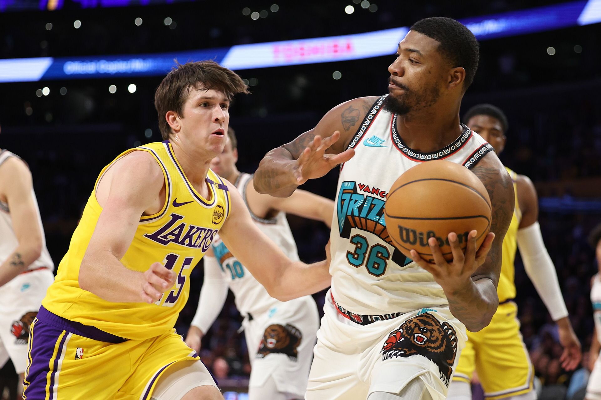 LOS ANGELES, CALIFORNIA - NOVEMBER 13: Marcus Smart #36 of the Memphis Grizzlies looks to pass the ball against Austin Reaves #15 of the Los Angeles Lakers during the first quarter at Crypto.com Arena on November 13, 2024 in Los Angeles, California.