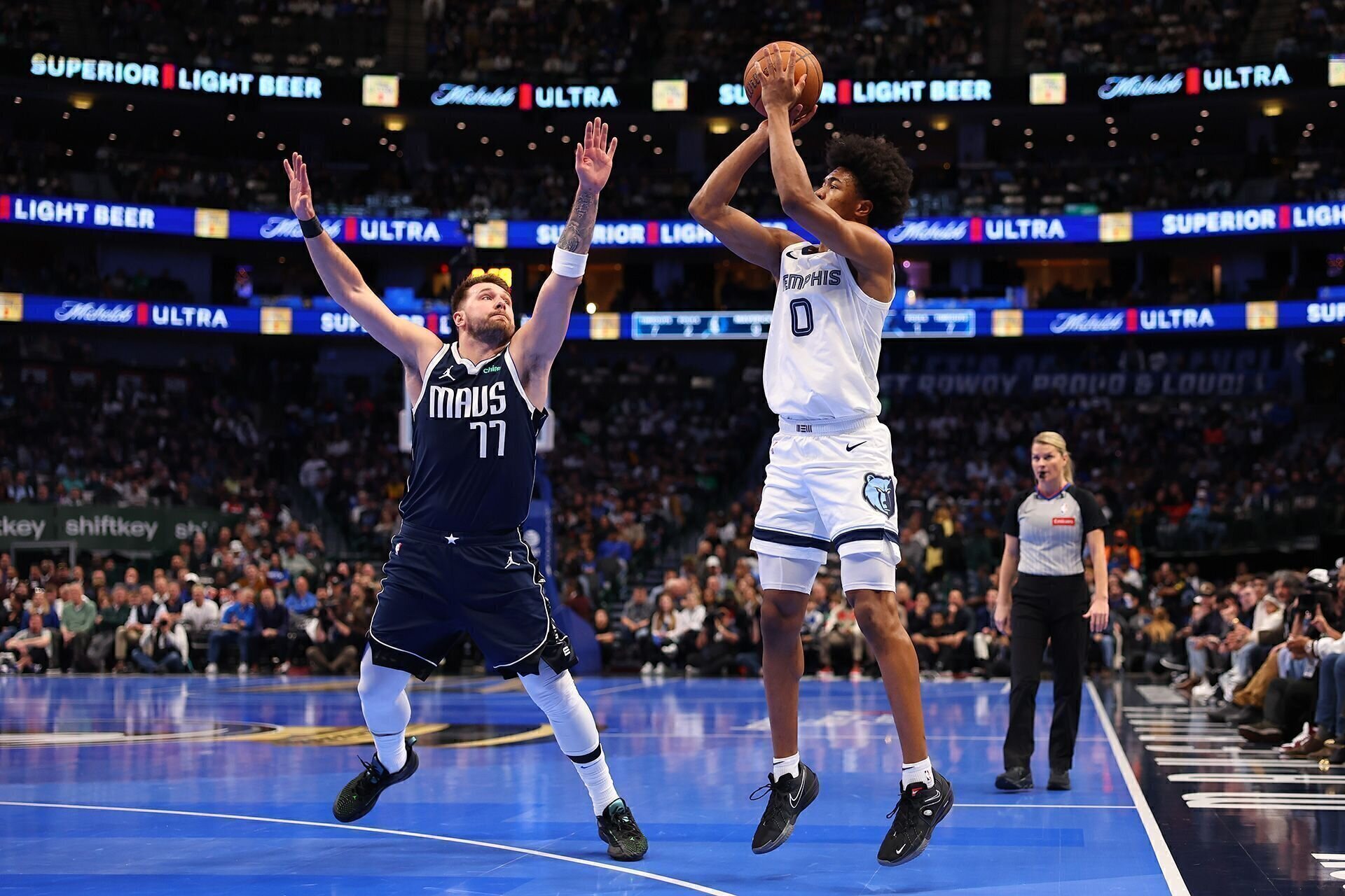 DALLAS, TEXAS - DECEMBER 03: Jaylen Wells #0 of the Memphis Grizzlies shoots over Luka Doncic #77 of the Dallas Mavericks during the first half of an Emirates NBA Cup game at American Airlines Center on December 03, 2024 in Dallas, Texas.