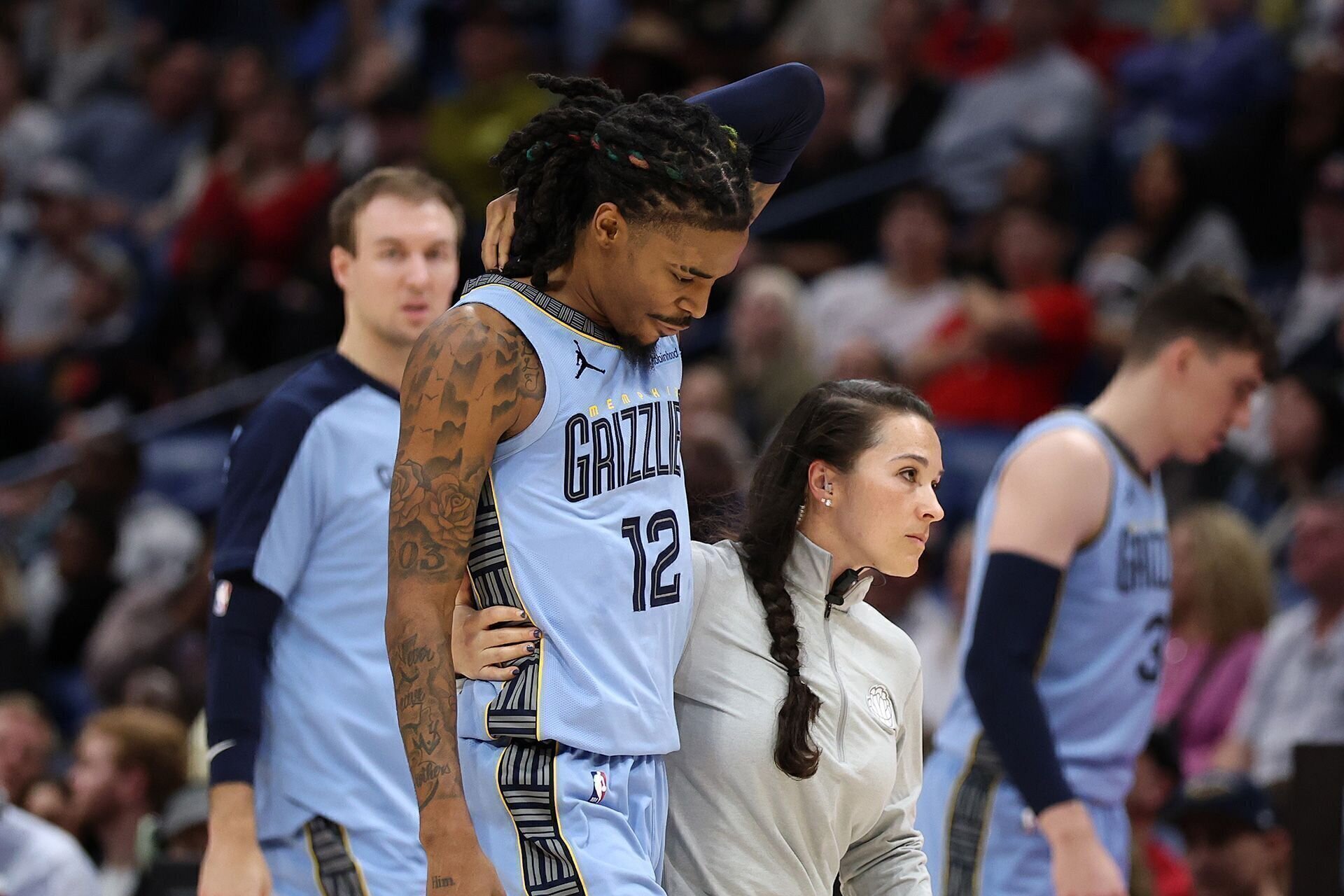 NEW ORLEANS, LOUISIANA - DECEMBER 27: Ja Morant #12 of the Memphis Grizzlies is injured during the game against the New Orleans Pelicans at Smoothie King Center on December 27, 2024 in New Orleans, Louisiana.