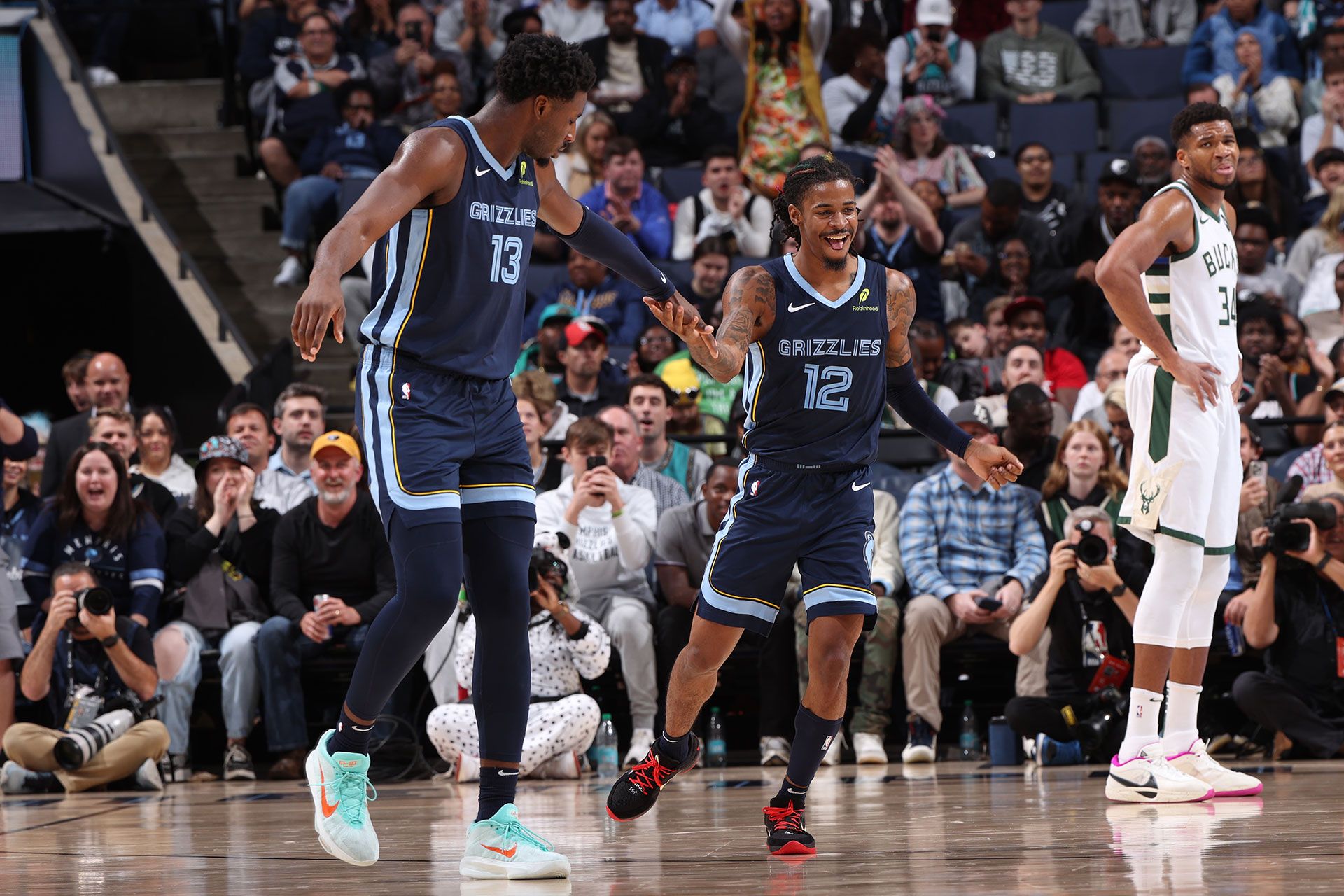 MEMPHIS, TN - OCTOBER 31: Jaren Jackson Jr. #13 and Ja Morant #12 of the Memphis Grizzlies high five during the game against the Milwaukee Bucks on October 31, 2024 at FedExForum in Memphis, Tennessee.