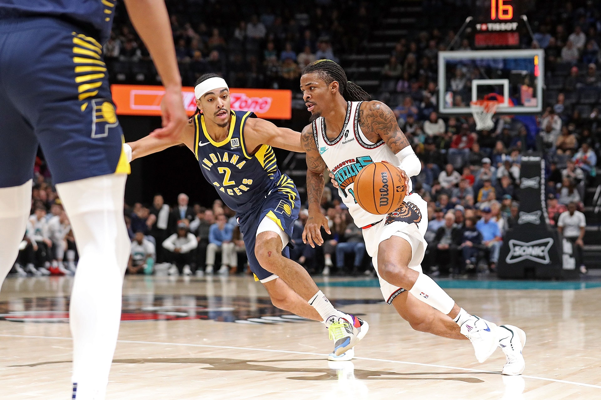 MEMPHIS, TENNESSEE - DECEMBER 01: Ja Morant #12 of the Memphis Grizzlies handles the ball against Andrew Nembhard #2 of the Indiana Pacers during the first half at FedExForum on December 01, 2024 in Memphis, Tennessee.