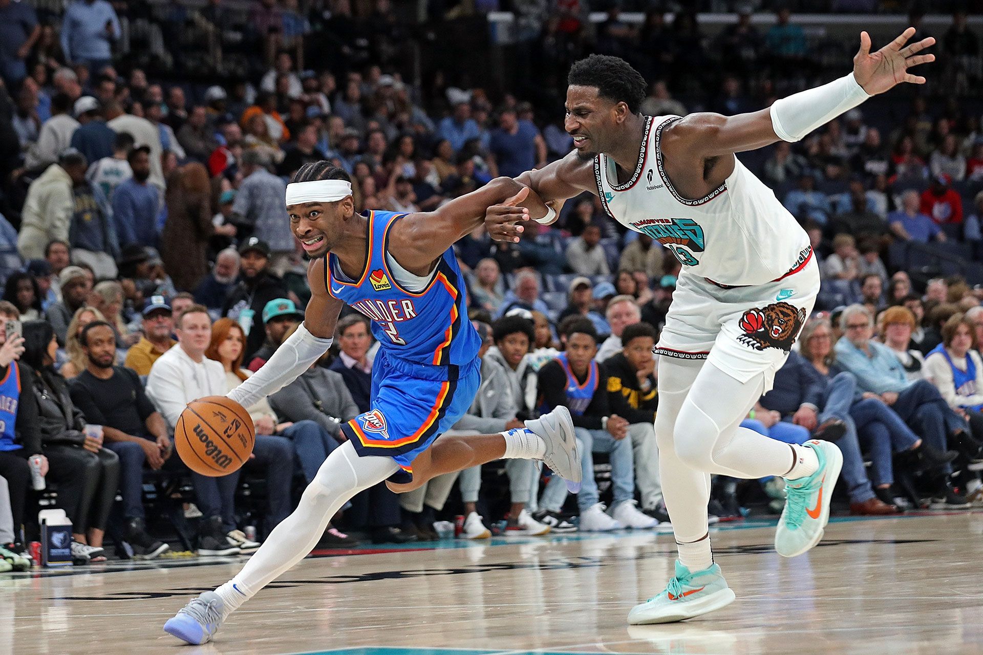 MEMPHIS, TENNESSEE - FEBRUARY 08: Shai Gilgeous-Alexander #2 of the Oklahoma City Thunder drives to the basket against Jaren Jackson Jr. #13 of the Memphis Grizzlies during the game at FedExForum on February 08, 2025 in Memphis, Tennessee.